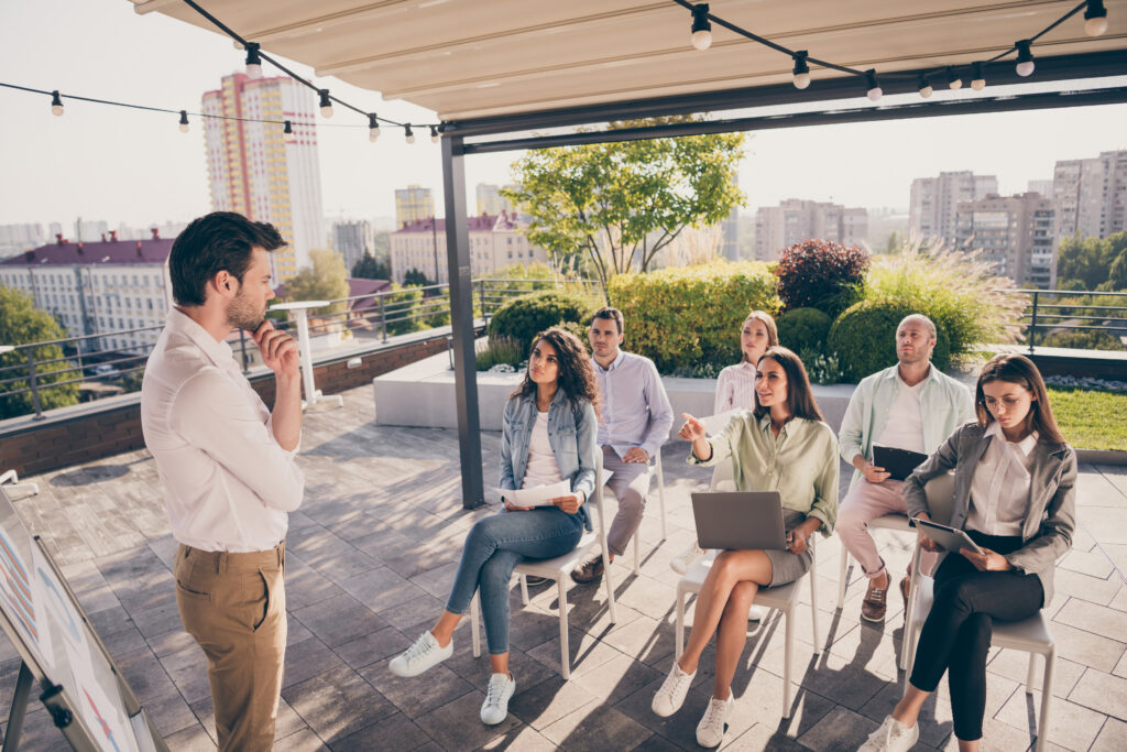 Photo of a financial professional having meeting with potential clients outdoors