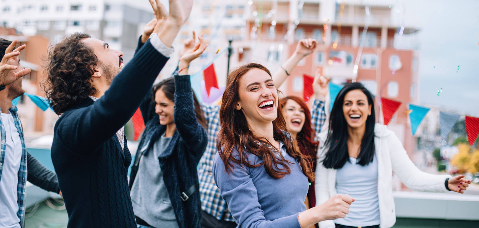 Happy group of younger generation having a gathering on a rooftop.