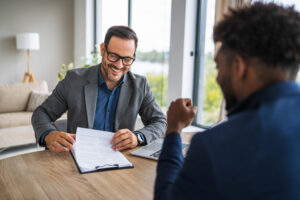 More experienced advisor mentoring young financial advisor to help grow the business for the future