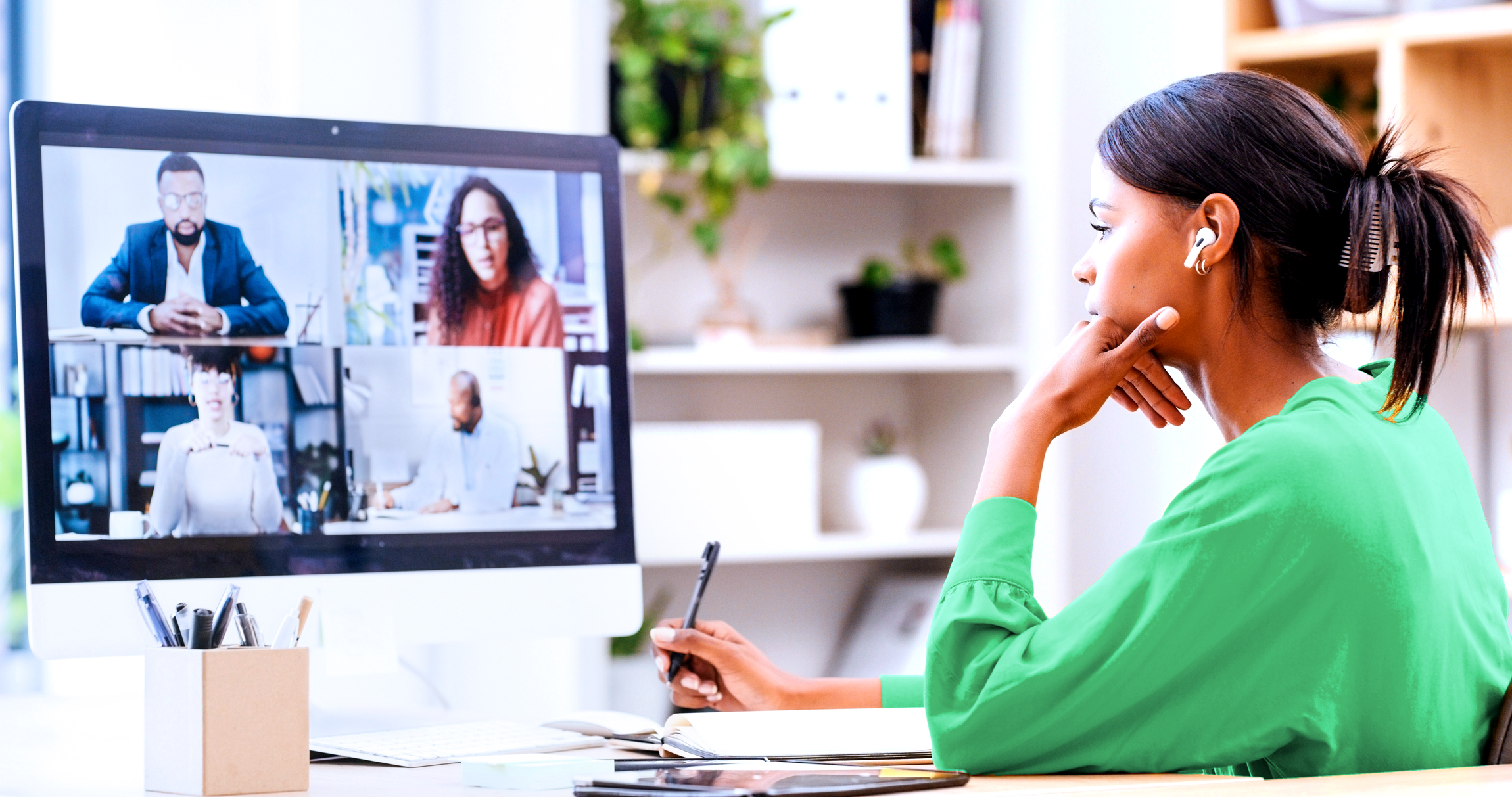 Woman having a video call on computer with financial coach over the Internet.