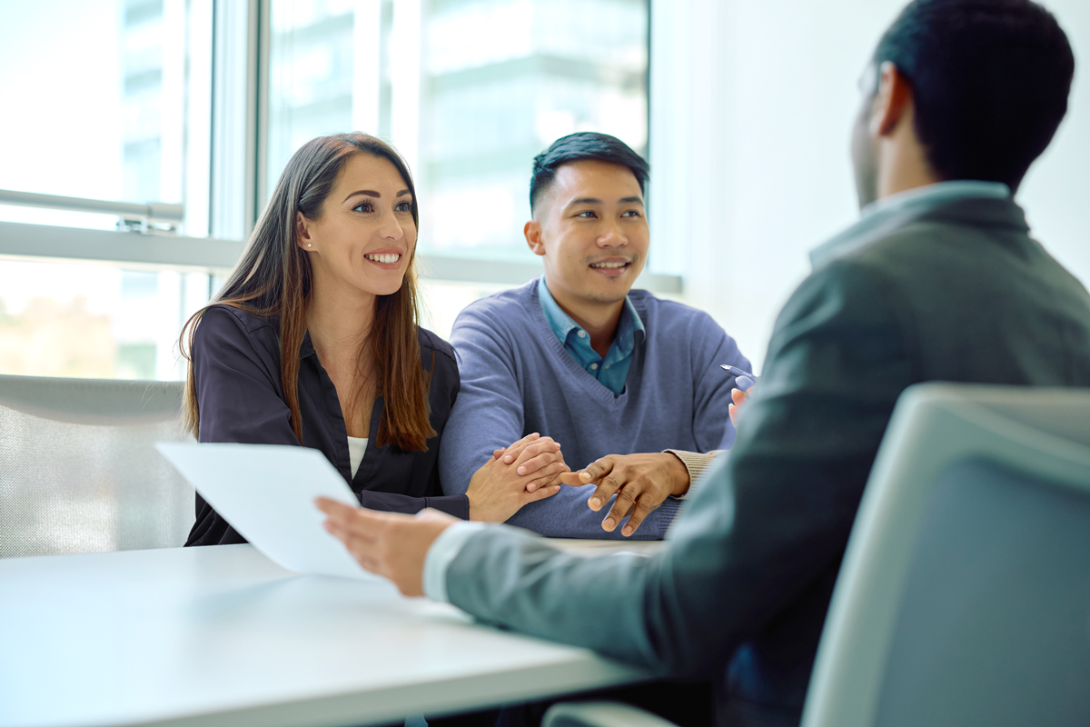 Financial advisor working with middle aged clients at office setting