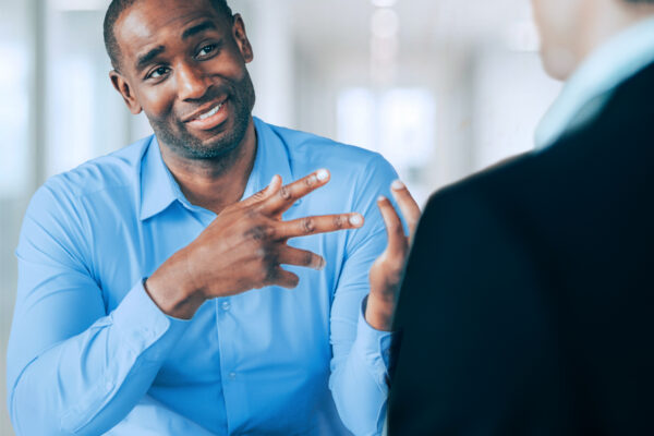 Confident financial advisor talking with client about their planning needs.