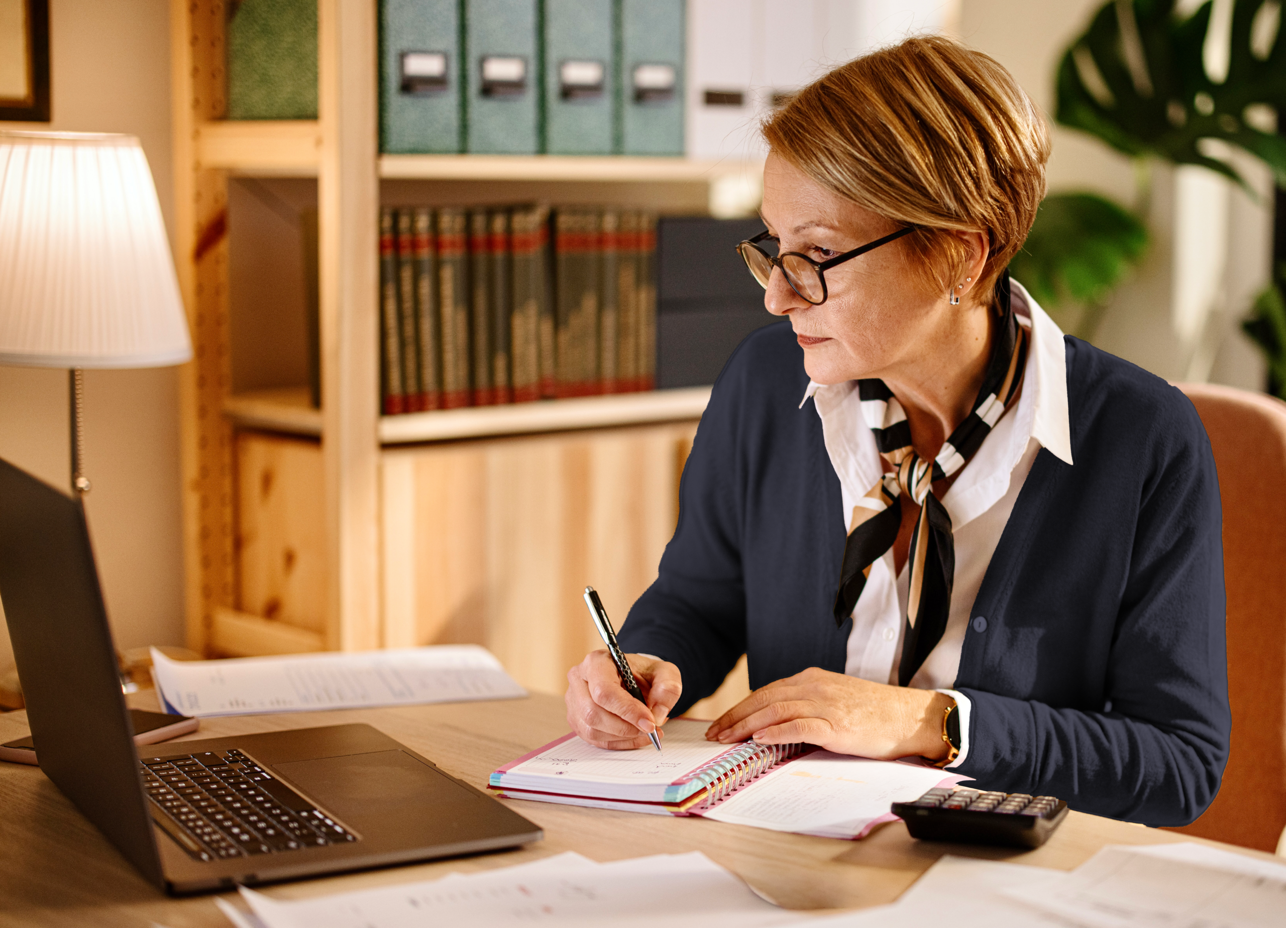 Older woman financially planning on her laptop