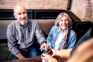 Older couple purchasing something with a credit card